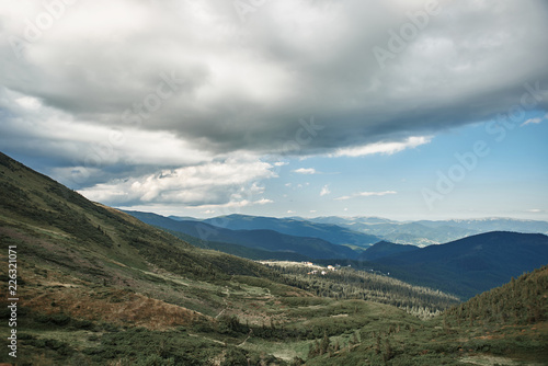 Mountain landscape. Horizontal photo of breathtaking landscape with beautiful mountains and clouds over them