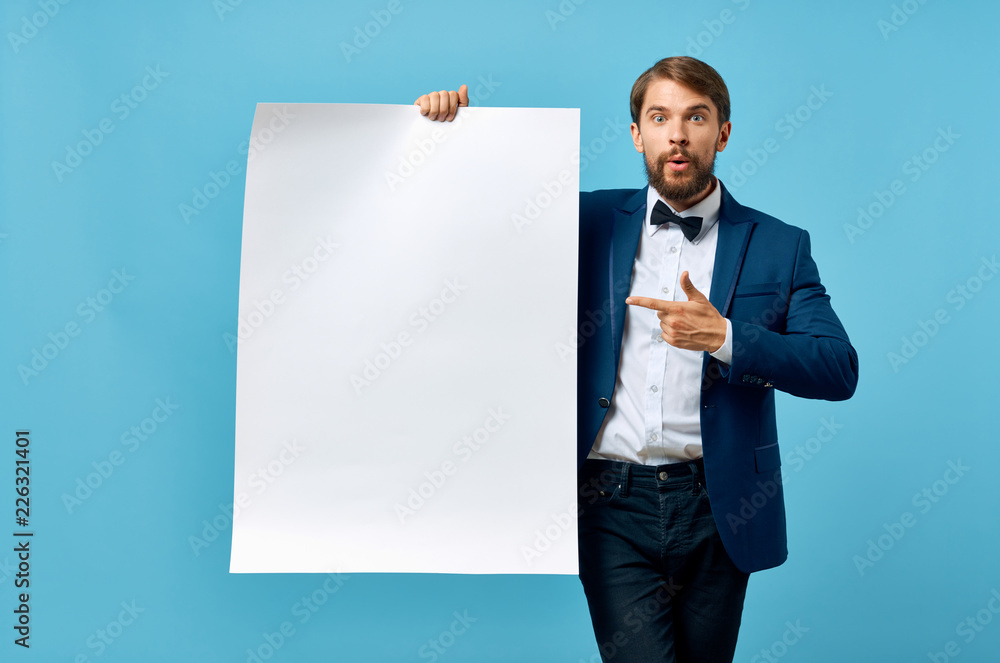 man in a suit shows his finger on a piece of paper man in a suit shows his finger on a piece of paper