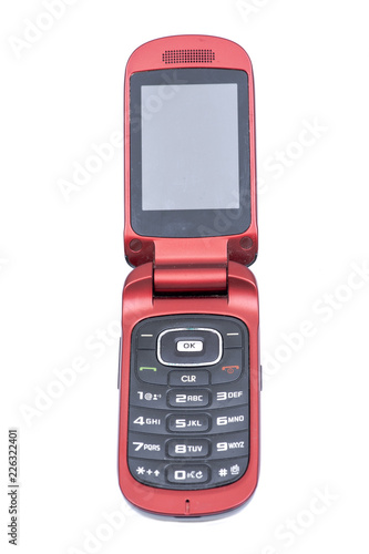 Old used flip cell phone isolated on white background