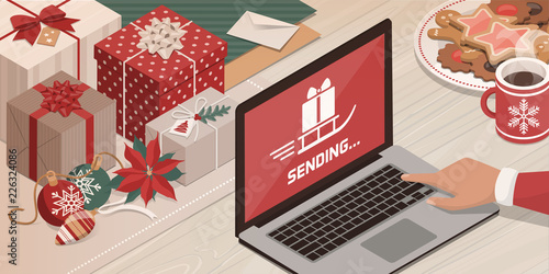 Santa sending gifts using his laptop