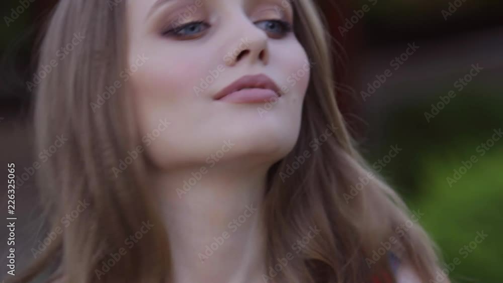 Positive wonderful girl with red hair and perfect smile is looking at camera. Moving hair from wind. 4k. Close-up portrait. Positive wonderful girl with red hair and perfect smile is looking at camera. Moving hair from wind. 4k. Close-up portrait.