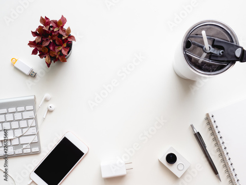 top view of office desk workspace with notebook, smartphone and gadget on white background with copy space, graphic designer, Creative Designer concept.