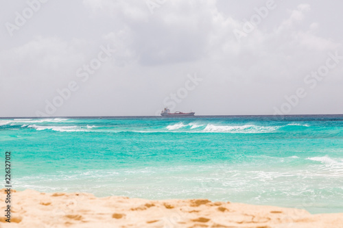 Tank ship passes the Coral Mist Beach on Barbados