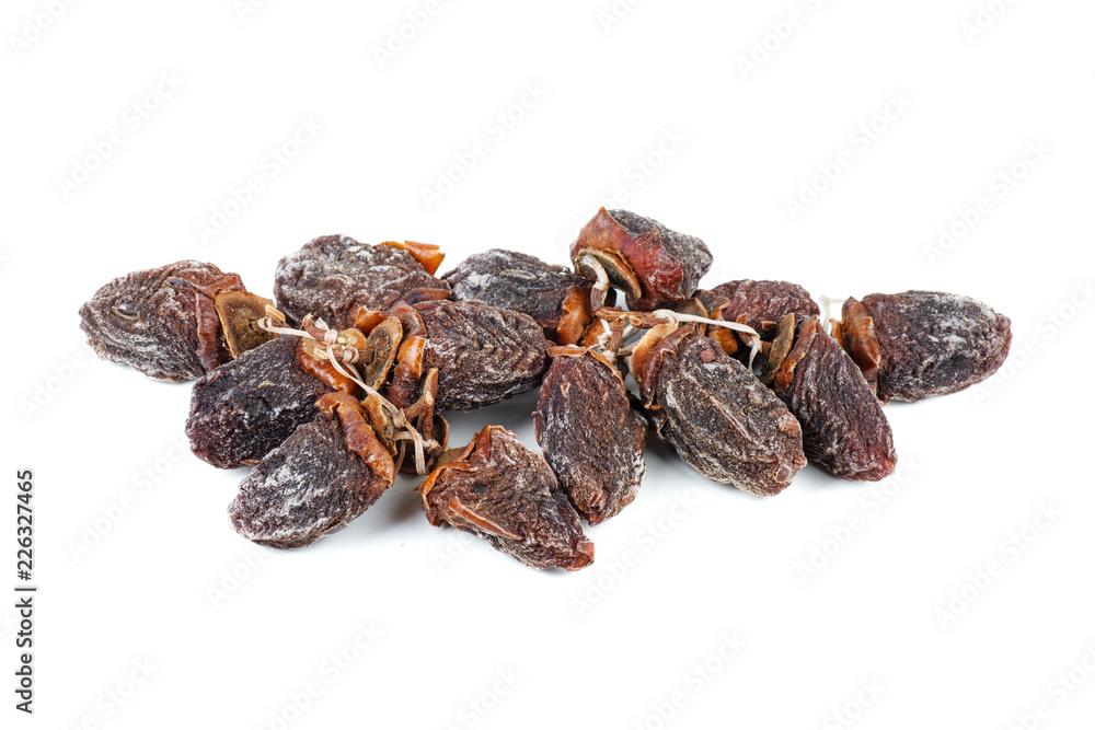 Pile of sun-dried persimmon fruits isolated on white background Pile of sun-dried persimmon fruits isolated on white background