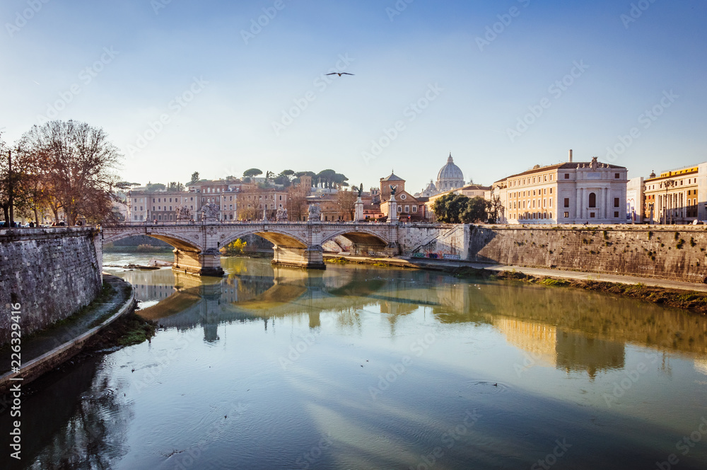 Spectacular view on the ancient bridge over the river in Rome