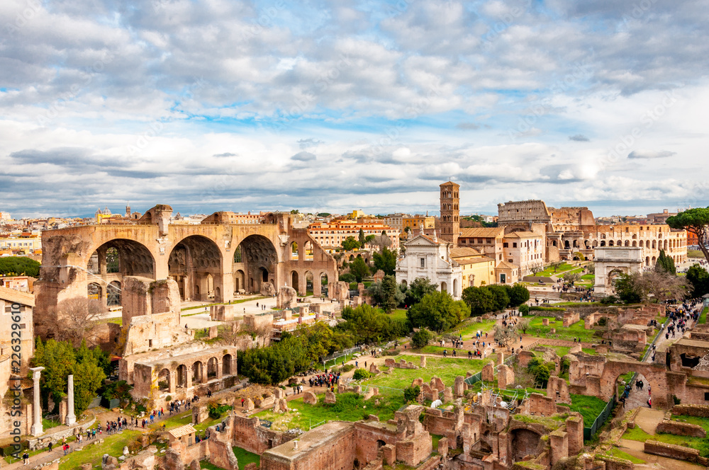 Roman forum and Colosseum from the high view in the sunny afternoon with blue sky and small clouds