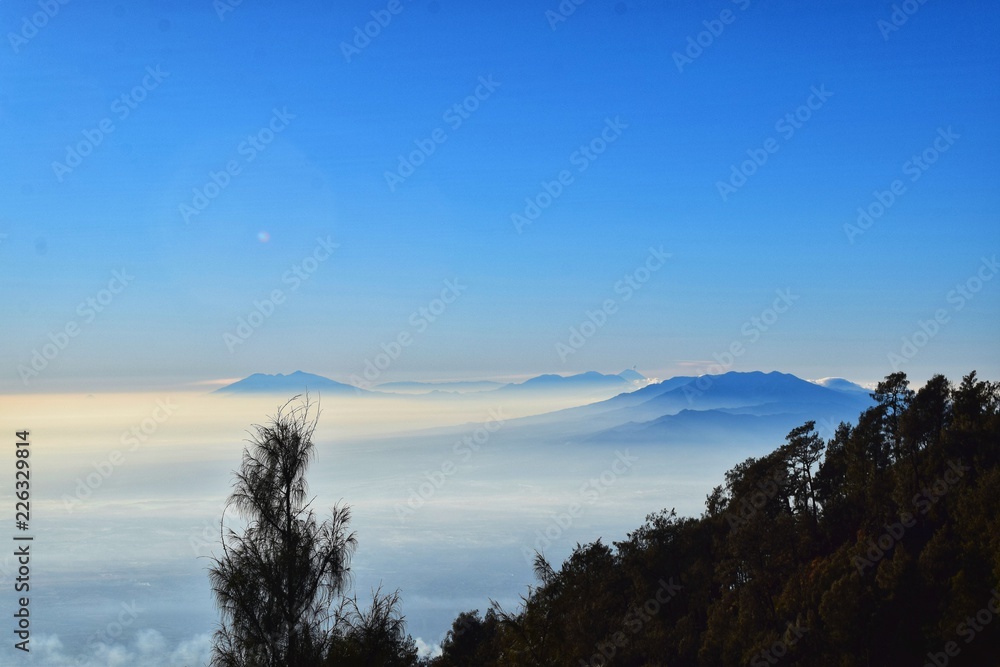 A view of summits from higher gound covered with mist 