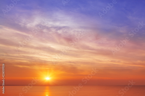 Beautiful  orange-pink sunset over the sea. Background image.