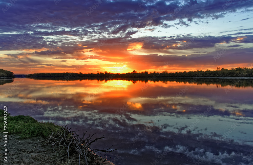 Bright saturated colors of dawn on the banks of the autumn river