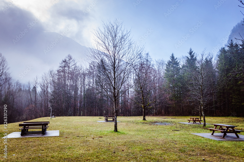Beautiful green lawn with wooden tables in Alps Beautiful green lawn with wooden tables in Alps