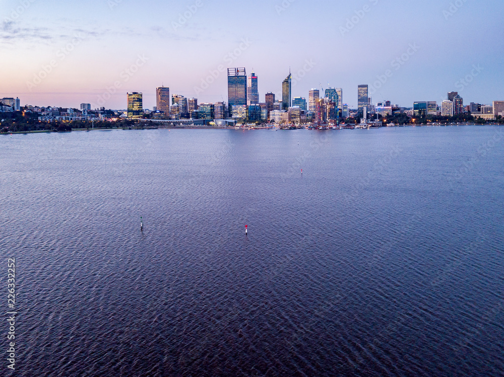 Aerial photograph of Perth City, Western Australia during dusk with the Swan River in the foreground.