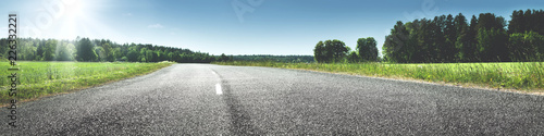 asphalt road panorama in countryside on sunny spring day photo