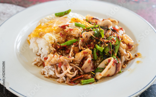 Rice topped with stir-fried  squid and basil
