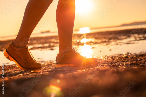 Women in the yellow shoes with sunset sea background