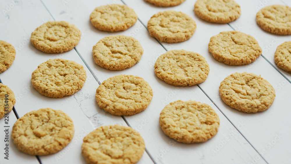 Gluten free healthy oatmeal cookies on white rustic wood bacground. Side view with copy space, flat lay. Gluten free healthy oatmeal cookies on white rustic wood bacground. Side view with copy space, flat lay.