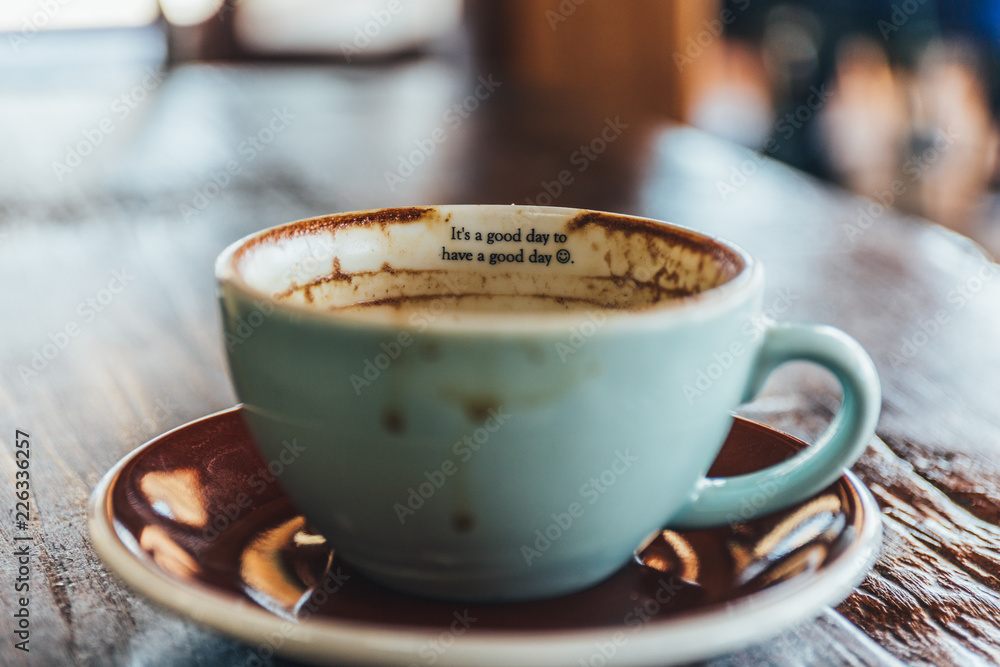 cup of coffee and beans on wooden table cup of coffee and beans on wooden table