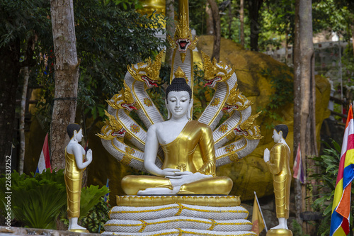 Beautiful Buddha statue with Naga heads at buddhist temple, Thailand.