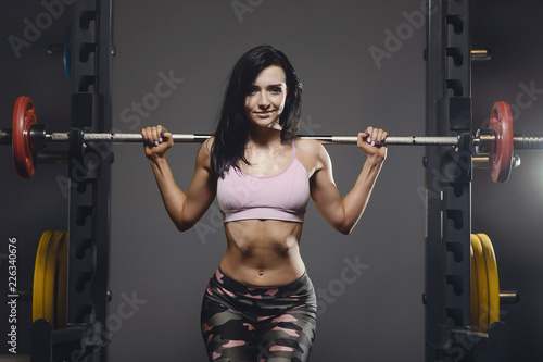 Beautiful sexy athletic young girl working out in gym