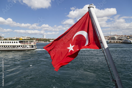 The flag scene from Turkey. The Turkish flag is fluctuating in the ferry on the sea.