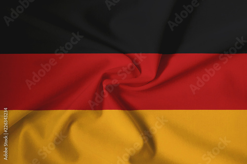 Waving German flag with a fabric texture