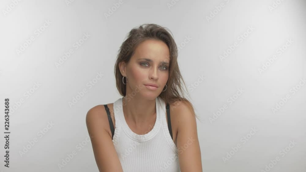 woman with straight long hair and light blue green eyes watching aside and to the camera woman with straight long hair and light blue green eyes watching aside and to the camera