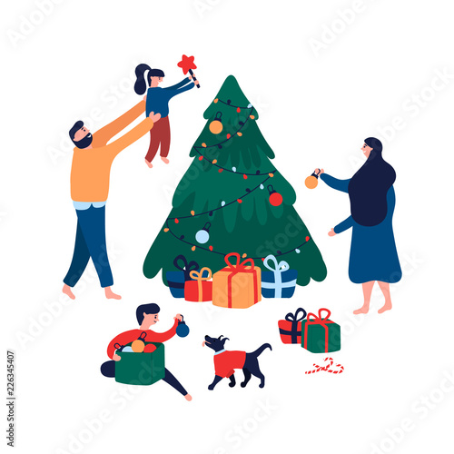 Happy family decorating Christmas tree with toys, star and garland for holiday