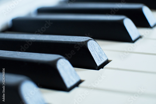 Macro closeup shot of a pianos white and black keys in a shallow depth of field