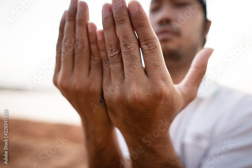 Close-up: Muslim men are praying for blessings from God © khampiranon