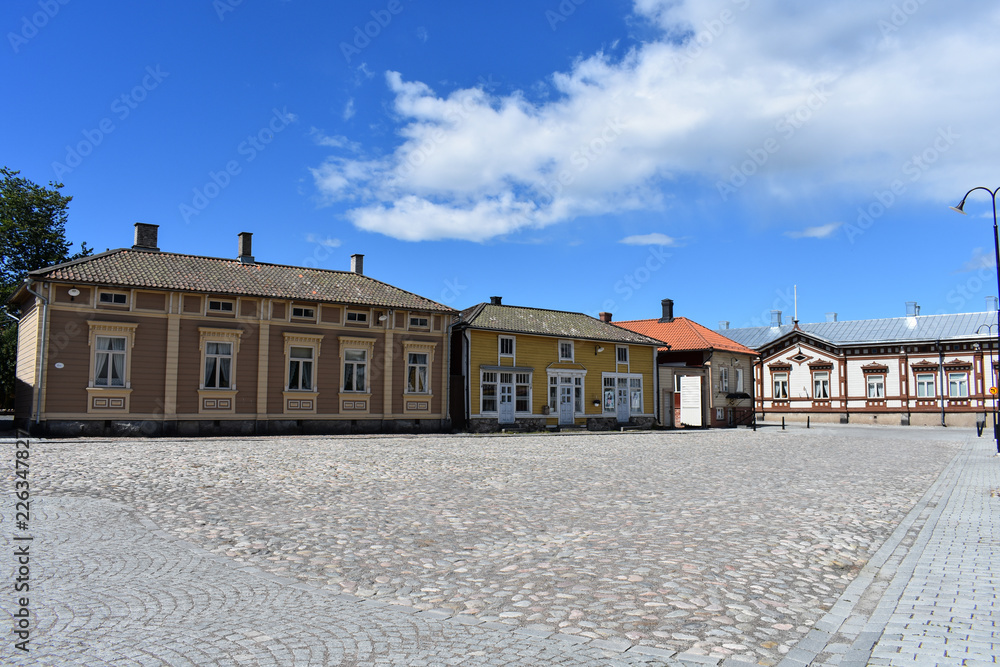 Buildings of Old Rauma are painted in different colors per building like these shops in white, yellow, and light brown.