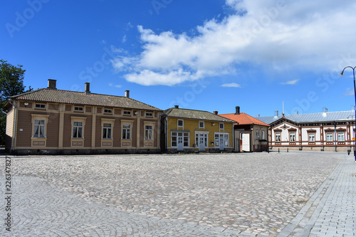 Buildings of Old Rauma are painted in different colors per building like these shops in white, yellow, and light brown.