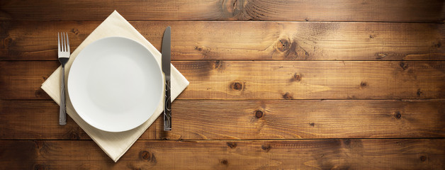 plate, knife and fork on napkin cloth