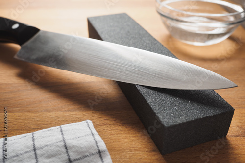 Knife sharpen with professional sharpening whetstone photo