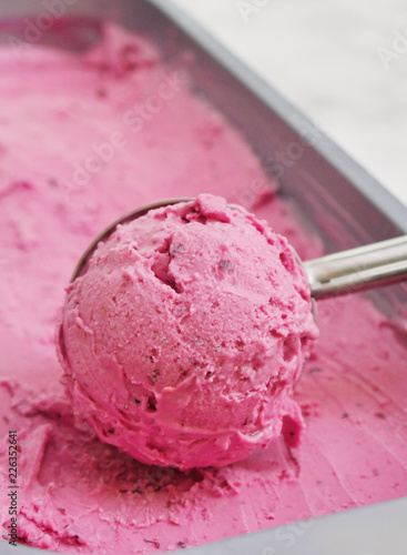 ice cream scoop, scooped out of a container with a utensil,Vanilla