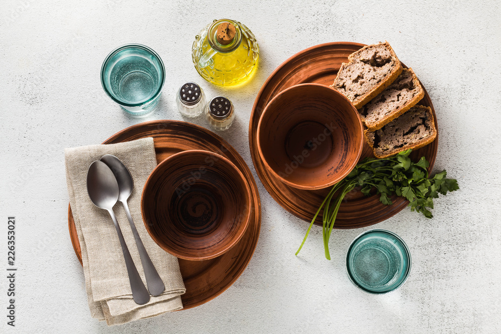 table setting. empty plates, spices, cutlery and olive oil. place to write text. copy space. collage template table setting. empty plates, spices, cutlery and olive oil. place to write text. copy space. collage template