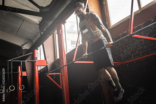 Strong man doing muscle up exercise