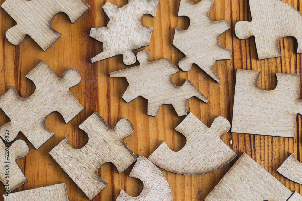 wooden jigsaw puzzle scattered brown on the floor of wooden planks, Business concept wooden jigsaw puzzle scattered brown on the floor of wooden planks, Business concept