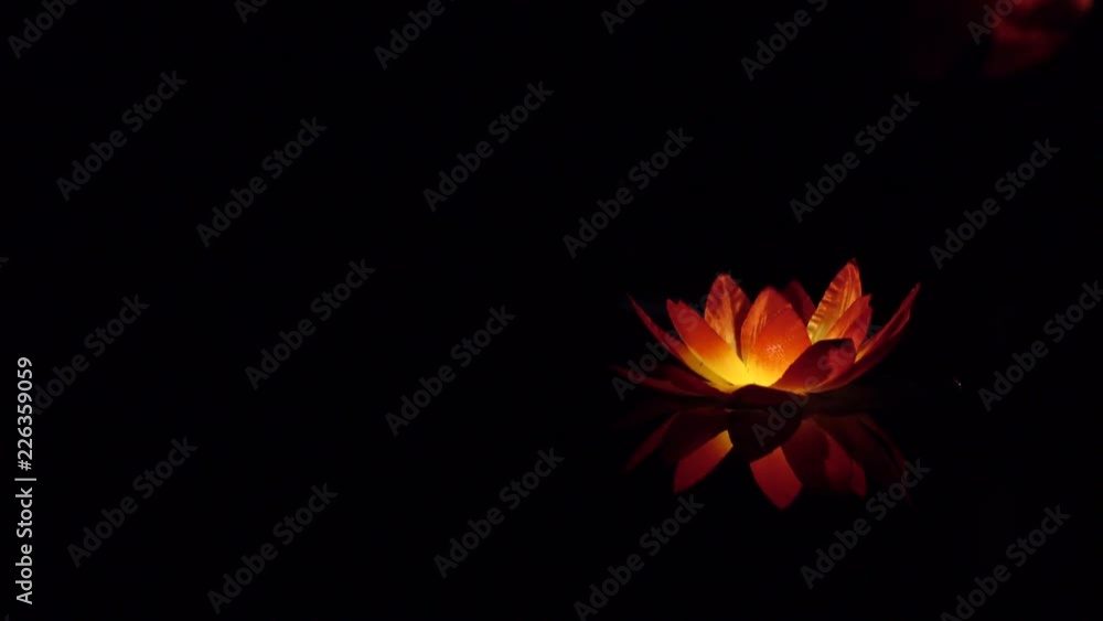 Festival of lanterns on the water. Water lantern in the shape of a Lotus with a candle flame floating at night on the water. Festival of lanterns on the water. Water lantern in the shape of a Lotus with a candle flame floating at night on the water.