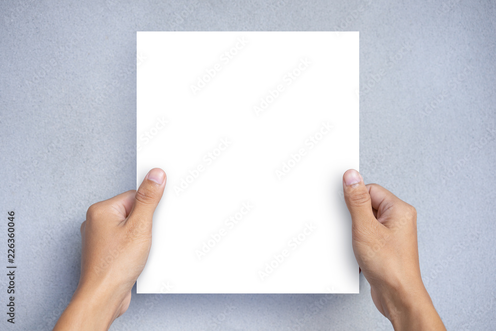 Hand holding a blank white paper sheet mock up on a gray background. Blank Brochure Template, Leaflet Hand holding a blank white paper sheet mock up on a gray background. Blank Brochure Template, Leaflet