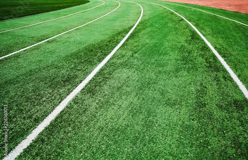 Running track with bright green artificial turf