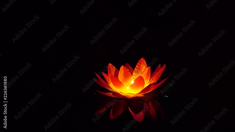 Festival of lanterns on the water. Water lantern in the shape of a Lotus with a candle flame floating at night on the water. Festival of lanterns on the water. Water lantern in the shape of a Lotus with a candle flame floating at night on the water.
