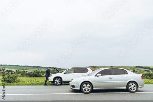 Fototapeta Naklejka Na Ścianę i Meble -  man stand near broken car with opened hood. emergency service