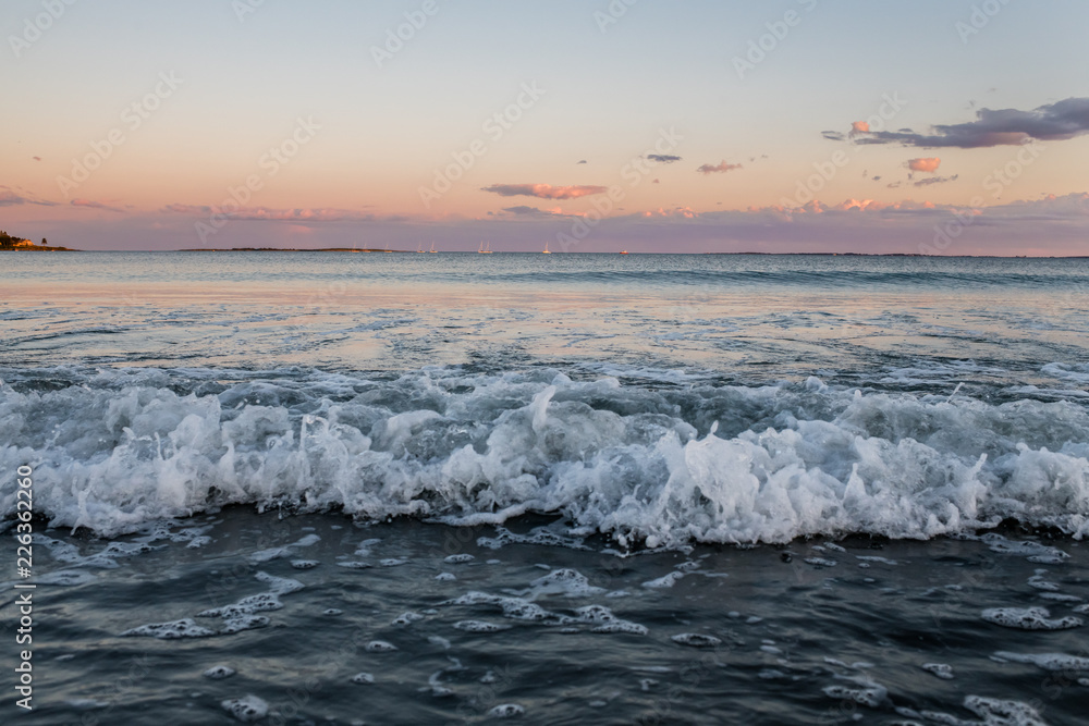Waves at sunset with cotton candy sky at Pine Point Beach in Scarborough Maine