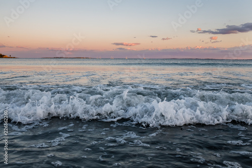 Waves at sunset with cotton candy sky at Pine Point Beach in Scarborough Maine