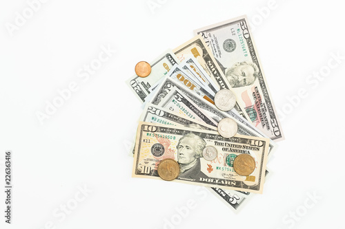 Coins with USA banknotes on white background. Flat lay, top view. Financial or business concept.