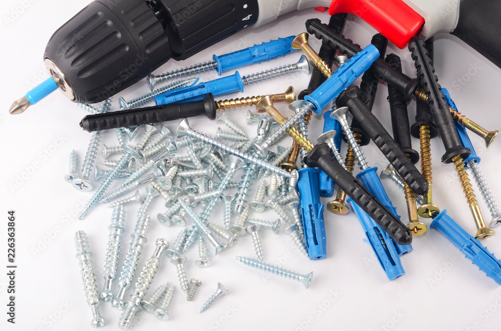 New screwdriver with screws and dowels close-up New screwdriver with screws and dowels close-up