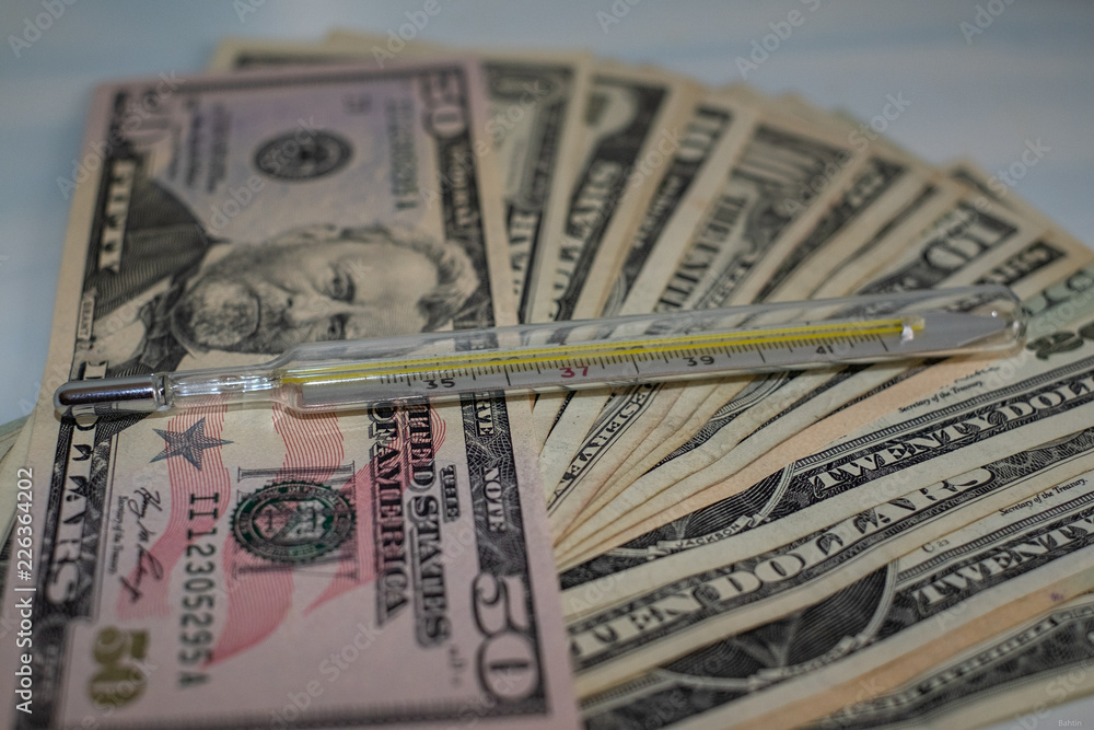 a lot of money and a thermometer a lot of money and a thermometer