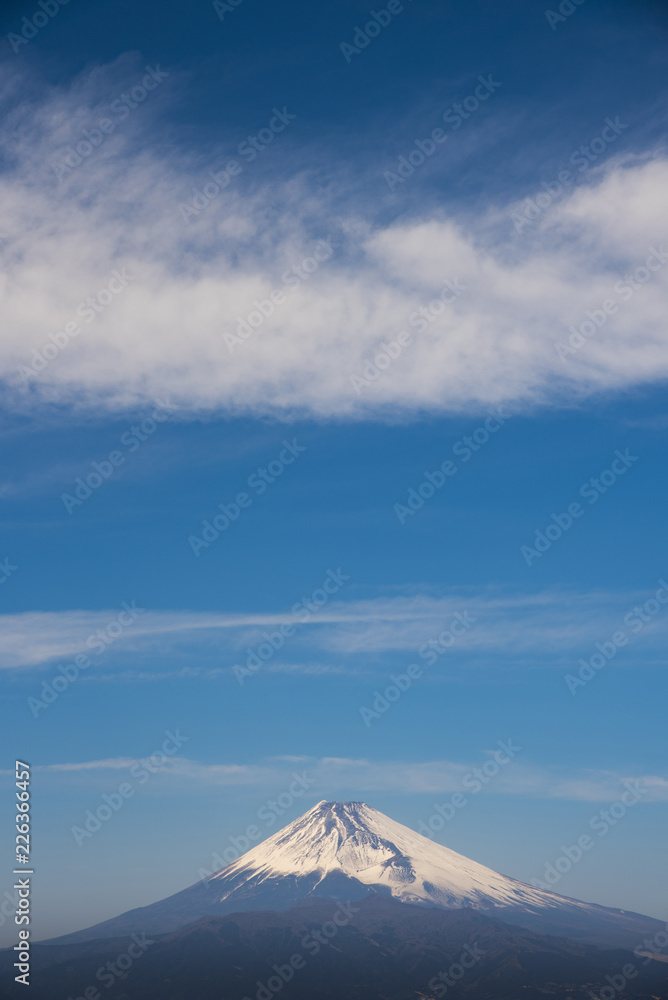 Beautiful cloud above Mt.Fuji with blue sky space in vertical landscape
