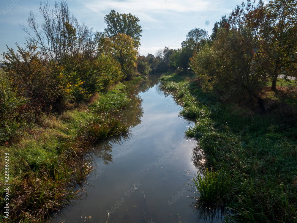 Scenic landscape view with a reflecting river and blue sky