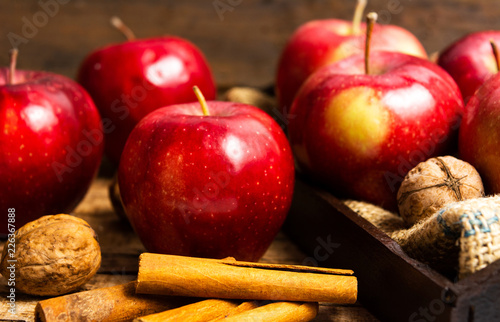 Apples and cinnamon on a rustic wooden table