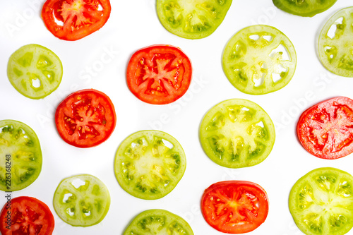 Green tomato slices on white background